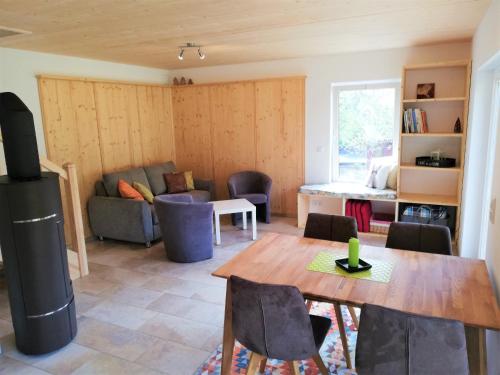 a living room with a table and a couch at Fewo bei Reuters - Haus Tellkoppe in Waldidylle