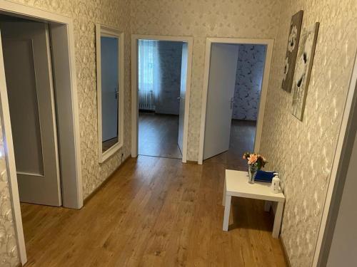 a room with a table with a vase of flowers on it at Ferienwohnung M&M in Herford