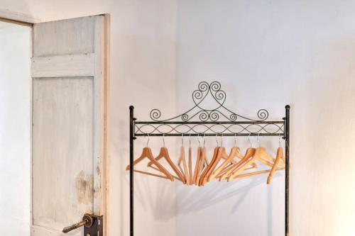 a iron rack with breadsticks on it next to a door at La Dimora della Quercia in Taviano