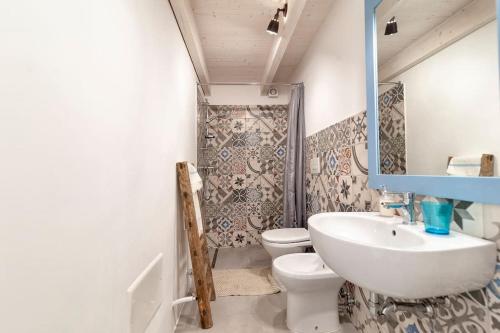 a bathroom with a sink and a toilet and a shower at La Dimora della Quercia in Taviano