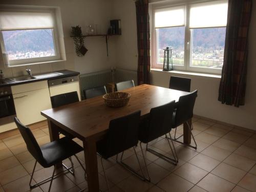 a kitchen with a wooden table and chairs at Haus Brunner in Döbriach