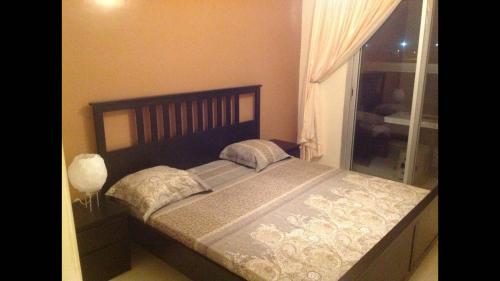 uma cama grande num quarto com uma janela em JOLI APPARTEMENT A DAKAR,ESPACES MAMELLE em Dakar