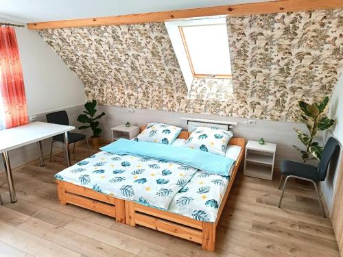 Schlafzimmer mit einem Bett, einem Tisch und einem Fenster in der Unterkunft Kukułka - Agroturystyka Nad Rzeczką. in Siennica