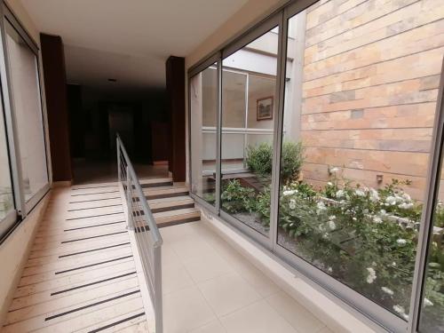 a hallway of a building with windows and a staircase at Departamento Caseros in Salta