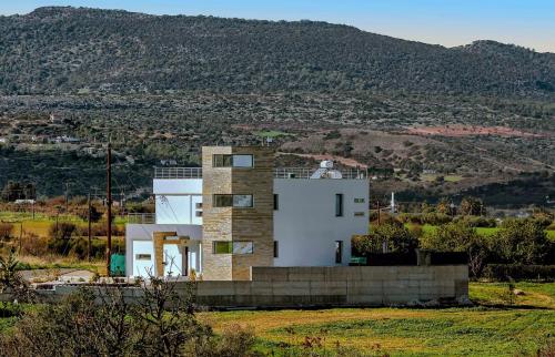 a house in the middle of a field at Eva Luxury Villa in Lachi