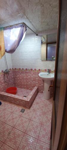 a bathroom with a bath tub and a sink at Dream House & Hostel in Sevan