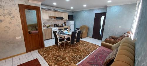 a kitchen and a living room with a table and chairs at Dream House & Hostel in Sevan