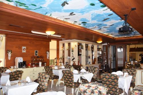 a dining room with tables and chairs and a ceiling at 2 KITARRAT Boutique Hotel & SPA in Durrës