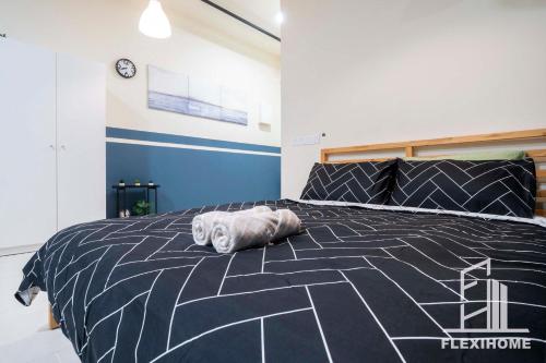 a white cat laying on a black bed at 9am-5pm, SAME DAY CHECK IN AND CHECK OUT, Work from Home, Comfy & Quiet Tamarind Suites-Cyberjaya by Flexihome-MY, in Cyberjaya