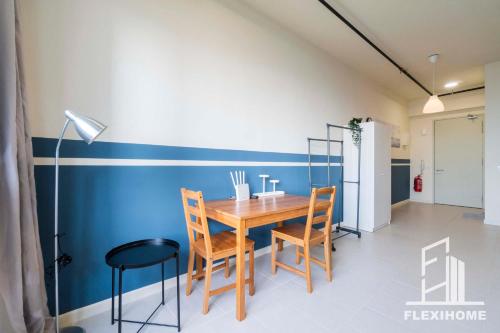 a dining room with a wooden table and chairs at 9am-5pm, SAME DAY CHECK IN AND CHECK OUT, Work from Home, Comfy & Quiet Tamarind Suites-Cyberjaya by Flexihome-MY, in Cyberjaya