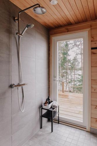 a bathroom with a shower with a glass door at Villa Varis in Jorvas