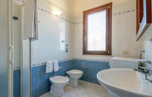 a blue and white bathroom with a toilet and a sink at VILLA SICILIA in Custonaci