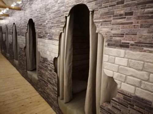 a brick wall with arched windows in a hallway at Õuna Puhketalu in Jõgeva