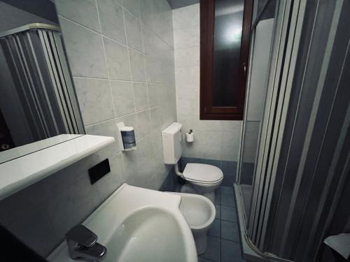 a small bathroom with a sink and a toilet at Hotel Le Corti in Ferrara