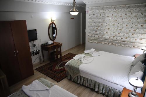 Postel nebo postele na pokoji v ubytování Basileus Hotel