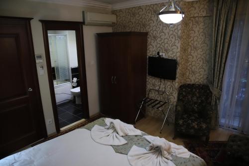 Postel nebo postele na pokoji v ubytování Basileus Hotel