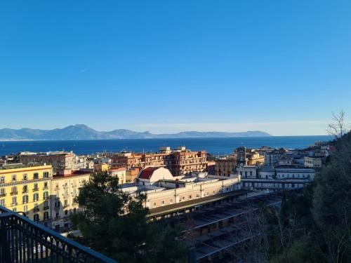 a view of a city with the ocean in the background at I Love Mergellina in Naples