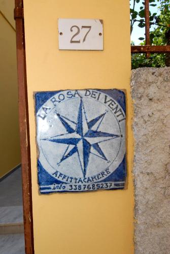 a sign on a wall with a star on it at La Rosa Dei Venti in Monterosso al Mare