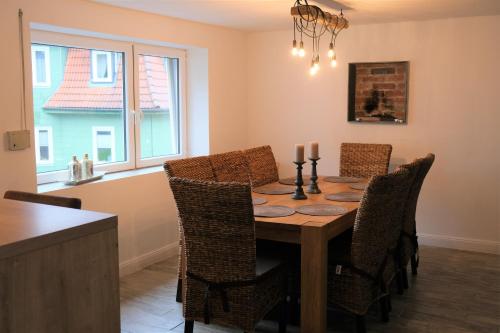 a dining room with a wooden table and chairs at Ursprüngliches Harzhaus für Aktive in Clausthal in Clausthal-Zellerfeld