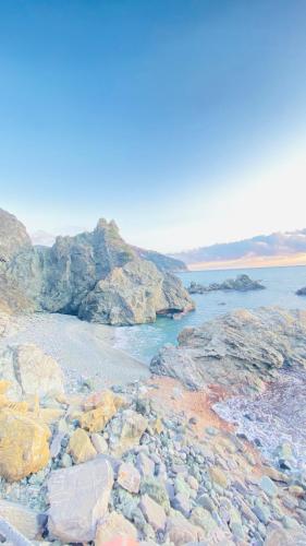 a group of rocks on a beach near the water at Villa Arancia Quiet, Central, Parking and Air Conditioning in Levanto