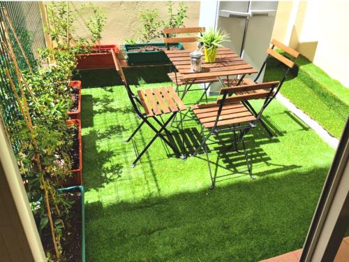 a patio with chairs and a table and grass at Estudio Príncipe David - VUT in Toledo