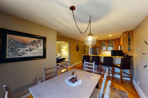 a kitchen and dining room with a table and chairs at Gore Creek Getaway in Vail