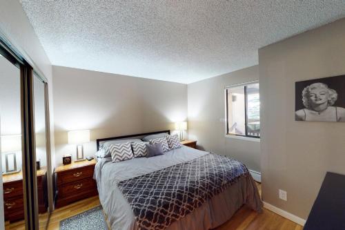 a bedroom with a bed and a large window at Gore Creek Getaway in Vail