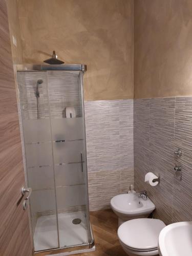 a bathroom with a shower and a toilet and a sink at Gloria Hostel Milano in Milan