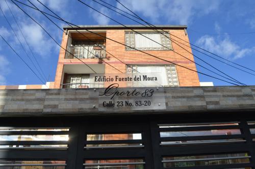 a building with a sign on top of it at Oporto 83 in Bogotá