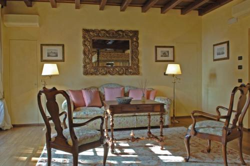 a living room with a couch and a table and two chairs at Hotel Torre di San Martino in Gazzola Di Rivalta
