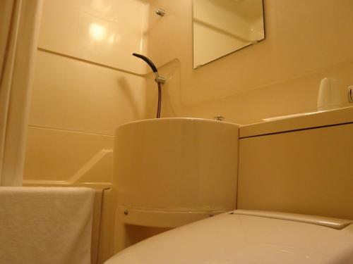 a bathroom with a toilet and a mirror at Hamamatsu Station Hotel - Vacation STAY 65834 in Hamamatsu
