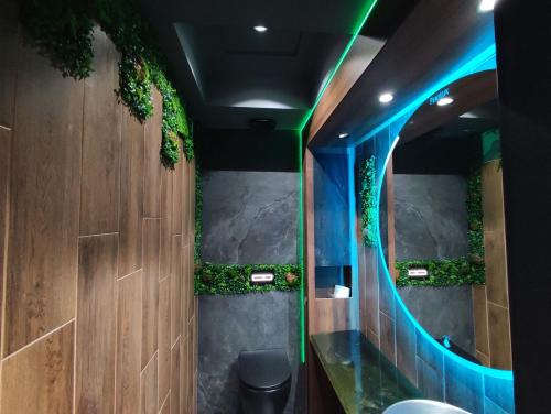 a bathroom with two sinks and a mirror with plants at PentLux - SPA Penthouse in the heart of Skopje in Skopje