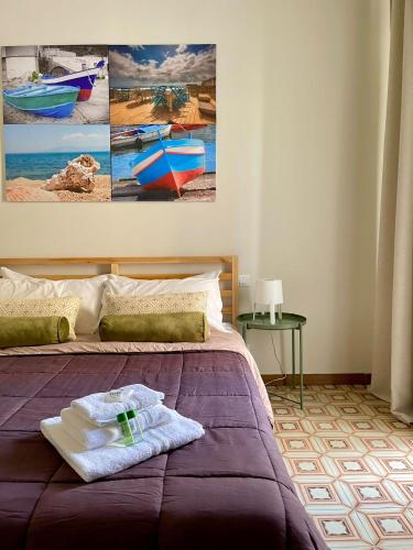 a bedroom with a bed with towels on it at amurimè in Porto Empedocle