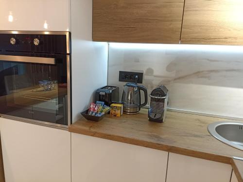 a kitchen with a counter with a coffee maker on it at Sky Luxury in Arandjelovac