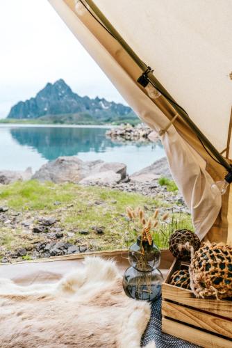 a tent with a view of a body of water at Skårungen - Hotel, Cabins and Camping in Kabelvåg