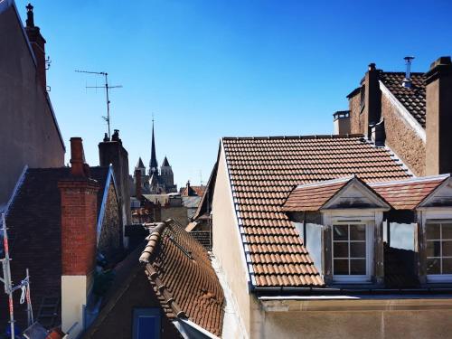 a view of roofs of buildings in a city at Appartement Cosy en Hypercentre - Le Petit Jules in Dijon