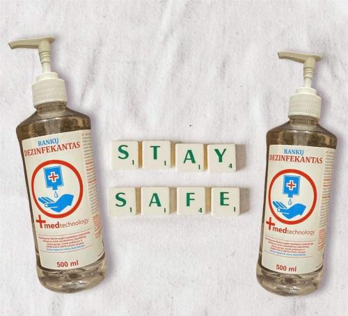 two bottles of water and a stay safe sign at Town Hall Square Apartments in Vilnius