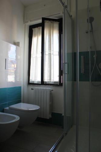 a bathroom with a toilet and a sink and a shower at B&B MARIMA 2 POSTI ORGOSOLO in Orgosolo