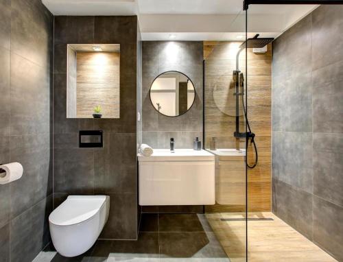 a bathroom with a toilet and a sink and a mirror at Luxury apartment Olivia in Mostar