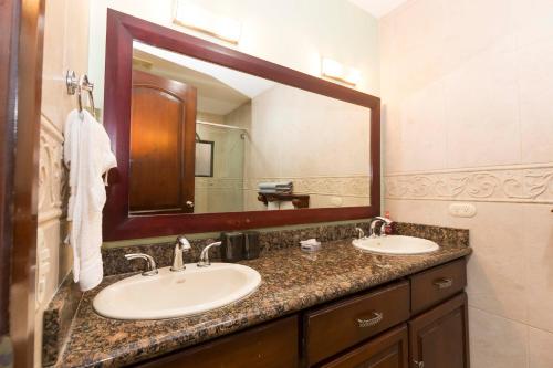 a bathroom with two sinks and a large mirror at Monte Carlo Luxury Condominiums in Jacó