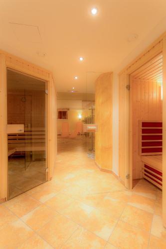 a large room with a hallway with a glass door at Apart Mado in Längenfeld