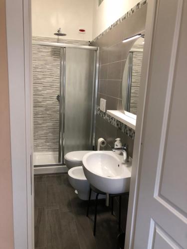 a bathroom with two sinks and a shower at B&B Trastevere in Bed in Rome