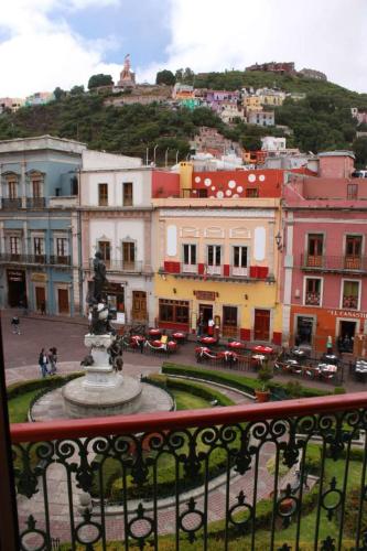 a view of a city with a fountain and buildings at Hotel de la Paz in Guanajuato