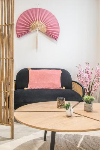 a living room with a couch and a table at Centre - Le Cloud - Parking in Drulingen