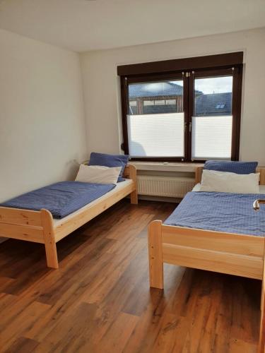 a room with two beds and a window at Gemütliches Fachwerk im Oberbergischen in Wiehl