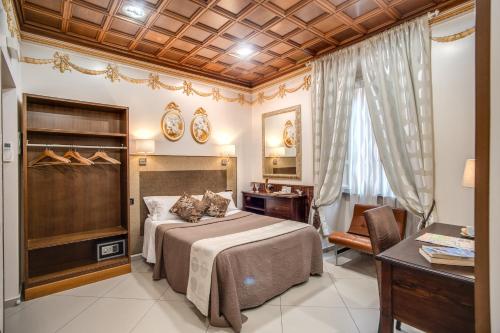 a bedroom with a bed and a table and a desk at Artemis in Rome