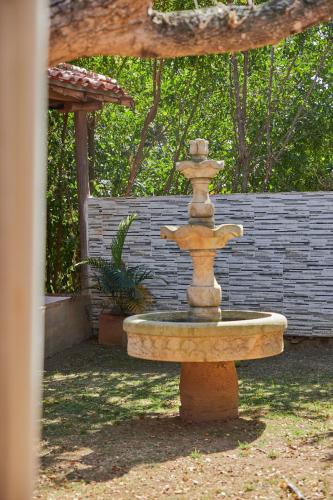 a stone fountain in a yard with aicked at Hotel Santos De Piedra - MARANATHA BARICHARA in Barichara