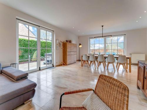 a living room with a couch and a table and chairs at Heers Retreat with Sauna in Heers