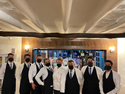 a group of men in suits and ties posing for a picture at Hotel Santos De Piedra - MARANATHA BARICHARA in Barichara