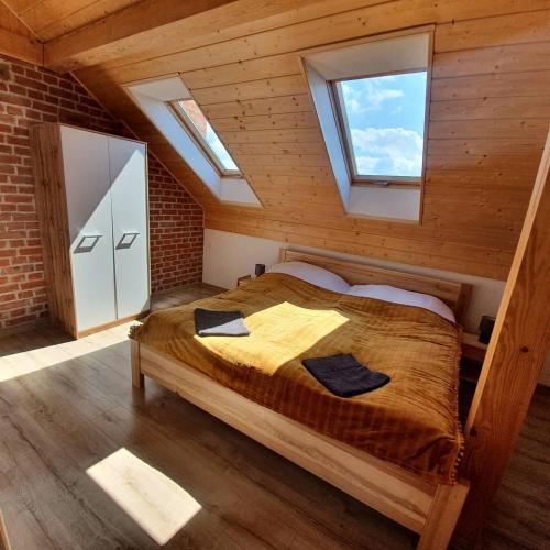 a bedroom with a large bed in a attic at Dziubanowo in Sanok